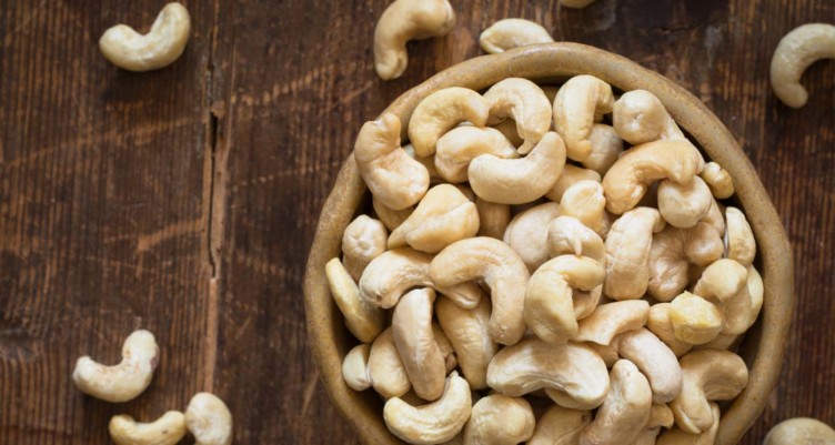 a lot of cashews nuts in the bowl on a table 